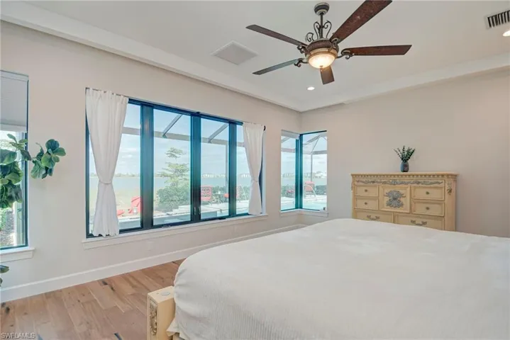 Bedroom featuring wood finished floors, a ceiling fan, and recessed lighting
