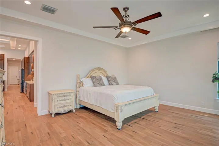 Bedroom featuring recessed lighting, light wood-style flooring, ceiling fan, and freestanding refrigerator