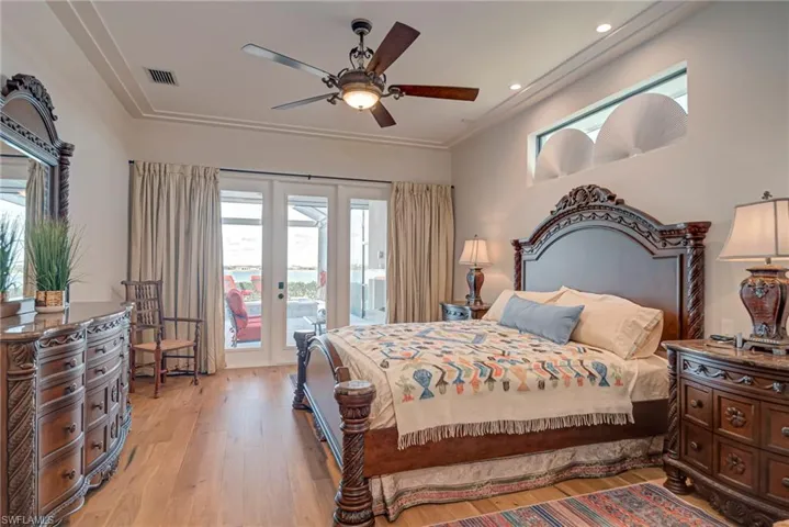 Bedroom with light wood-style floors, a ceiling fan, access to outside, and recessed lighting