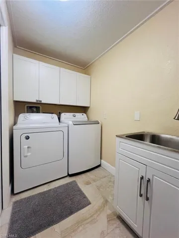 Main house laundry room with storage shelves and laundry sink