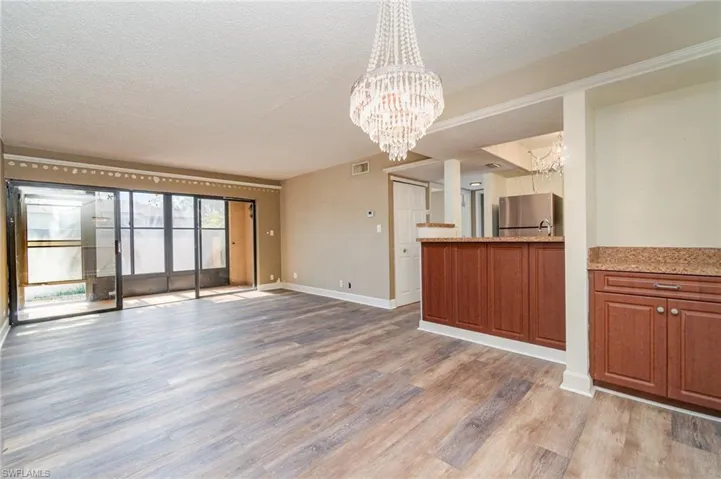 Dining area with built in dry bar view towards living room, kitchen and screened in lanai