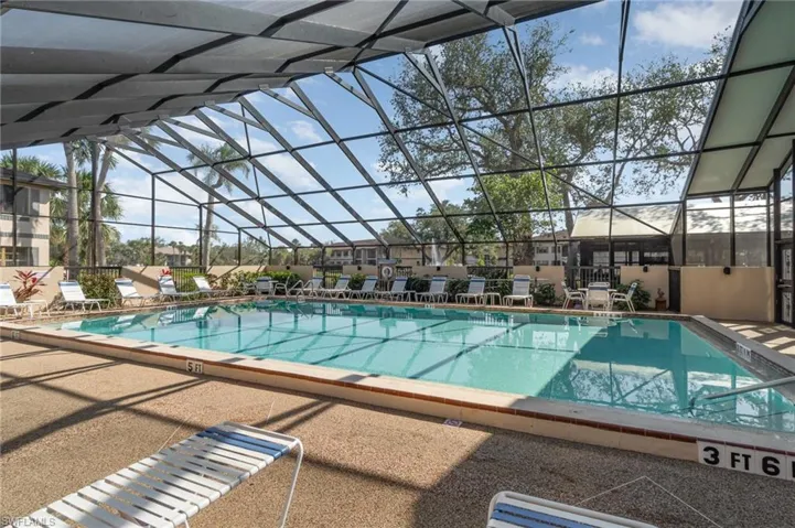 Screen in community HEATED Pool overlooking a serene water view.