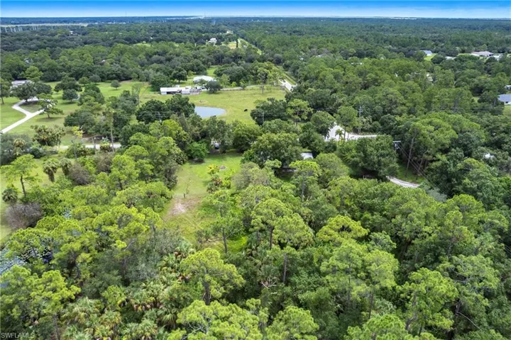 Aerial view of property's location featuring a forest