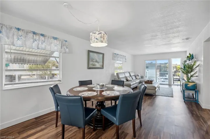Dining space with dark wood-type flooring and a textured ceiling