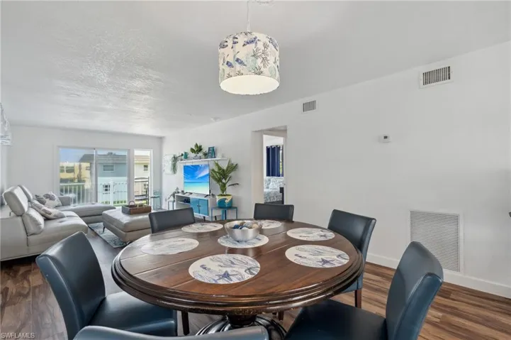 Dining space featuring a textured ceiling and dark wood-type flooring