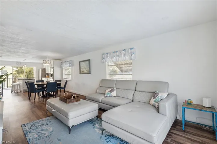 Living room featuring a healthy amount of sunlight and dark hardwood / wood-style flooring
