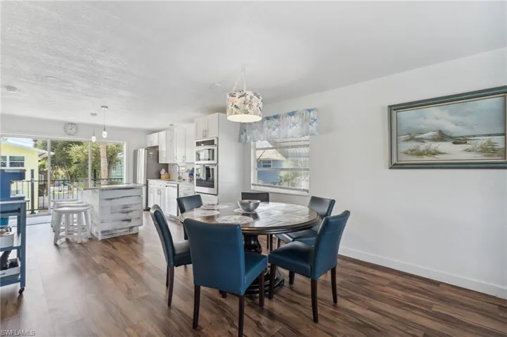 Dining room featuring a textured ceiling, dark hardwood / wood-style floors, and sink