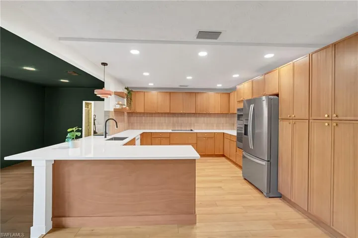 Completely renovated kitchen is spacious, offers solid wood cabinetry and quartz countertops.