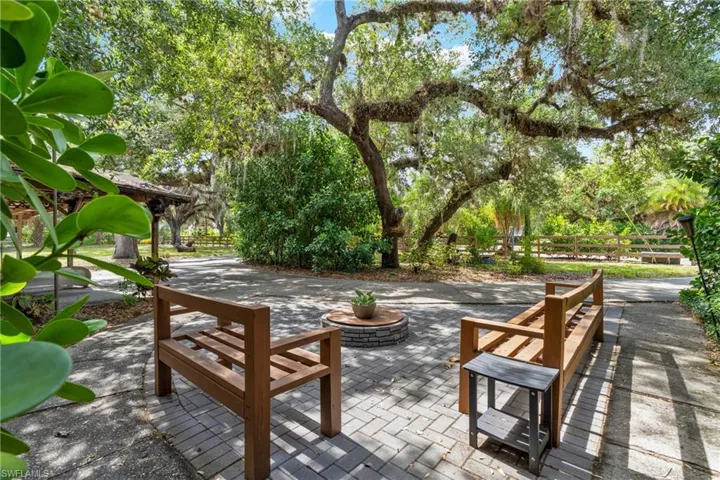 Custom built patio with firepit and bench seating.