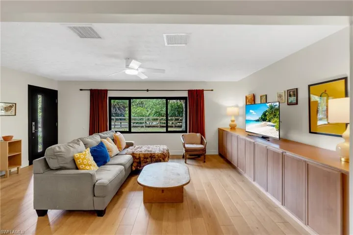 Living room has large front windows with view of the front private front lawn and plenty of natural lighting.