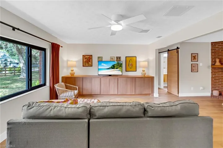 Living room offers plenty of natural light and custom built in storage.