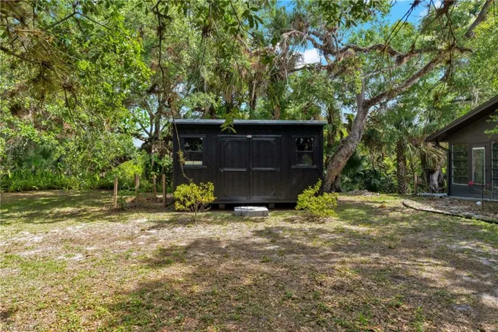 Storage shed located to the left of the main home is perfect for either additional storage, workshop, home office or she-shed.