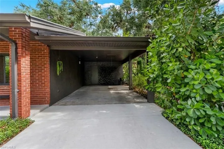 Covered carport with access door to the utility area/ second bathroom.