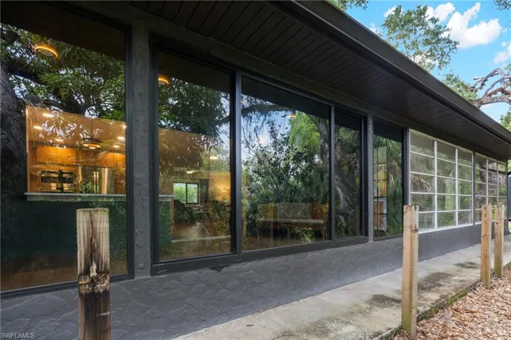 Back of the home with large impact windows.