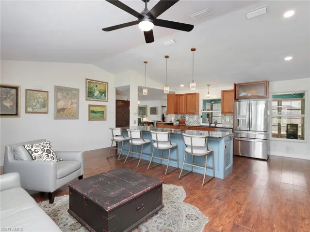Open-concept living area featuring rich wood-finish flooring