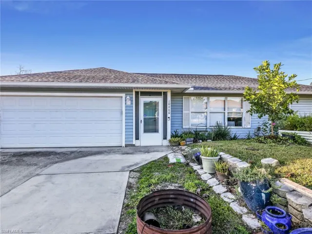 Light blue siding residential exterior with a white garage door