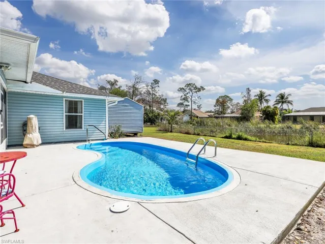 Freeform swimming pool with concrete decking