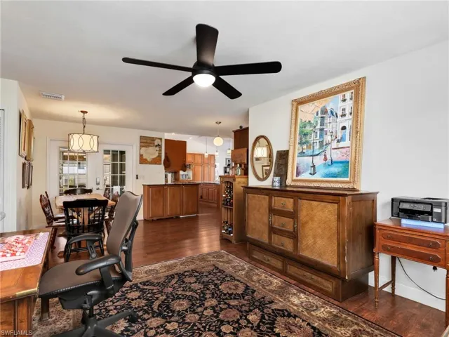 Open-concept interior featuring wood-finish flooring, a ceiling fan, and recessed lighting