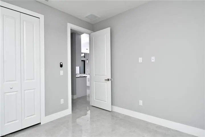 Unfurnished bedroom featuring a closet and light tile patterned floors