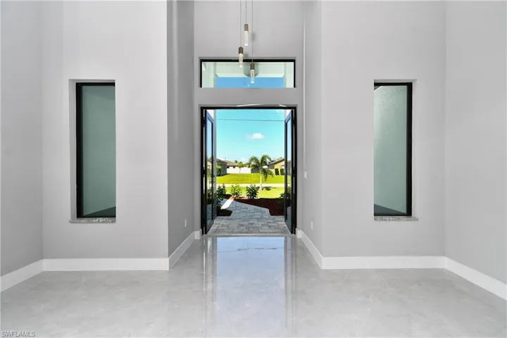 Entryway featuring tile patterned flooring and a high ceiling