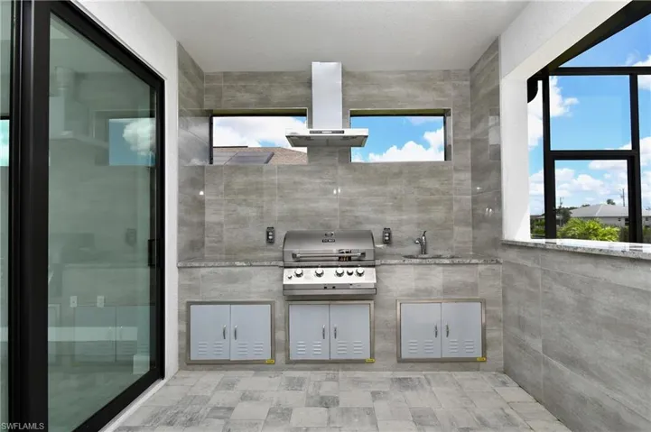 Bathroom featuring tile patterned flooring, tile walls, and sink
