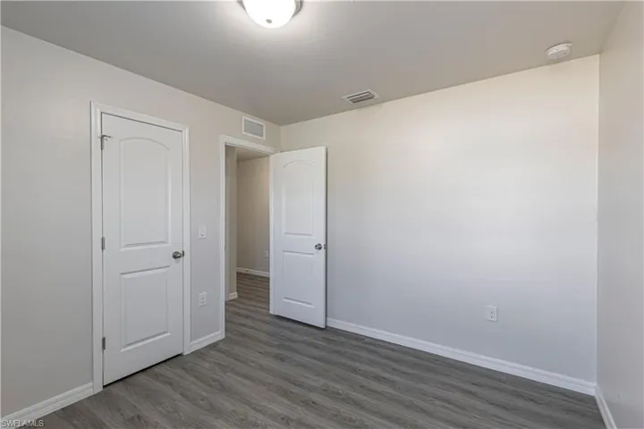 Unfurnished bedroom featuring baseboards and wood finished floors