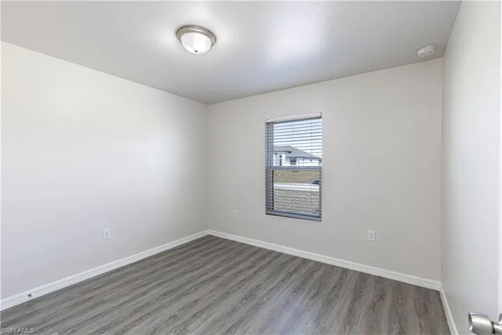 Empty room with wood finished floors and baseboards