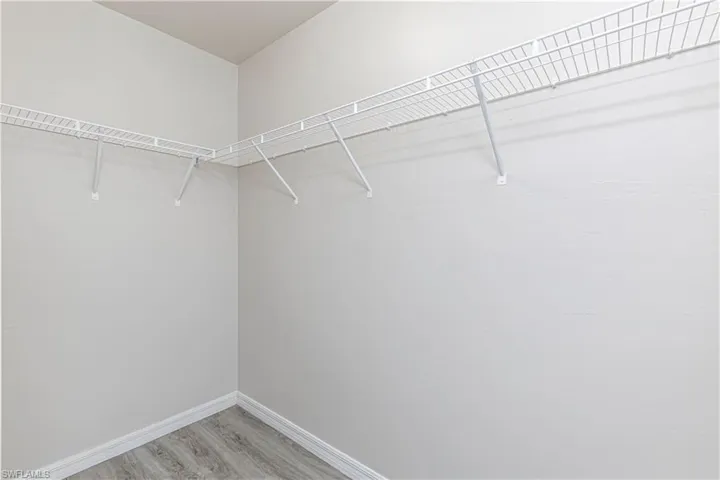 Walk in closet featuring light wood-style flooring