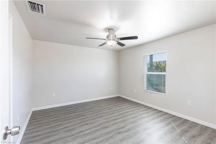 Unfurnished room featuring wood finished floors and ceiling fan
