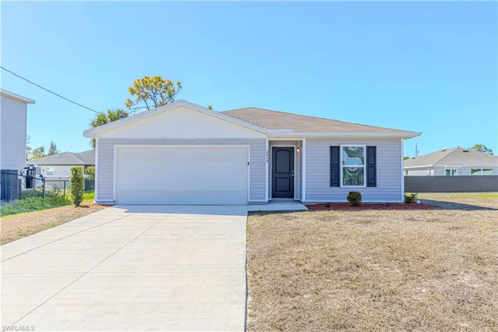 Ranch-style home with driveway and an attached garage