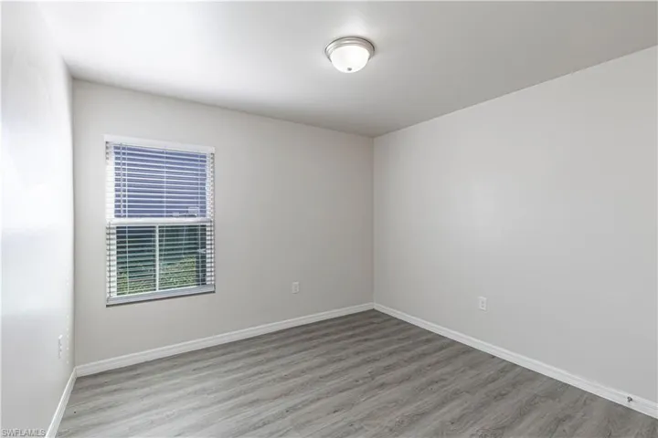 Unfurnished room with light wood-type flooring and baseboards