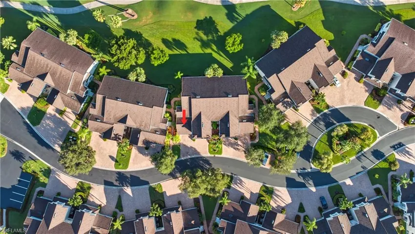 Aerial view of property and surrounding area featuring nearby suburban area