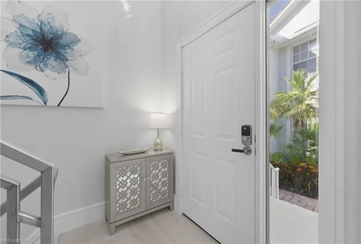 Foyer entrance featuring healthy amount of natural light and light wood-type flooring