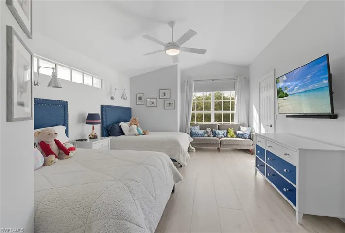 Bedroom featuring vaulted ceiling, a ceiling fan, and light wood-style flooring