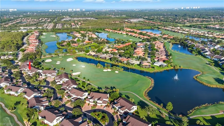 Aerial overview of property's location featuring a local golf course, nearby suburban area, and a nearby body of water