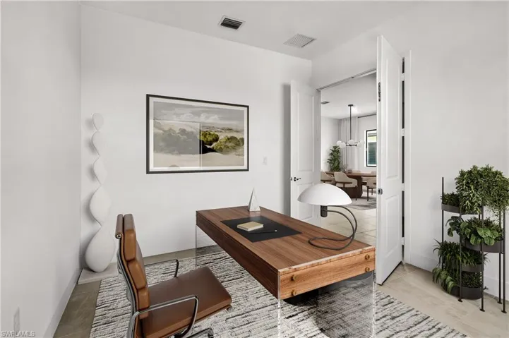 DEN - Office space featuring light tile patterned flooring and baseboards