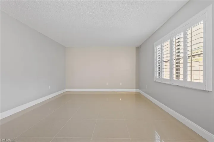 Spare room featuring light tile patterned flooring and a textured ceiling