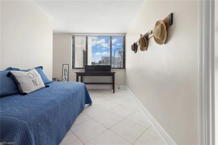Bedroom featuring light tile patterned flooring and a textured ceiling