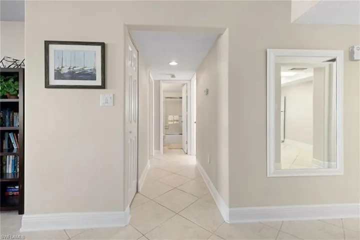 Hall featuring light tile patterned flooring