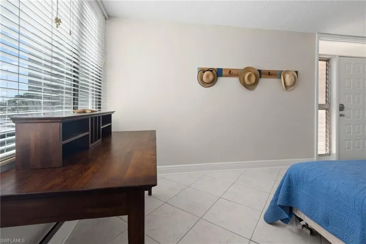 Bedroom with light tile patterned floors and a textured ceiling