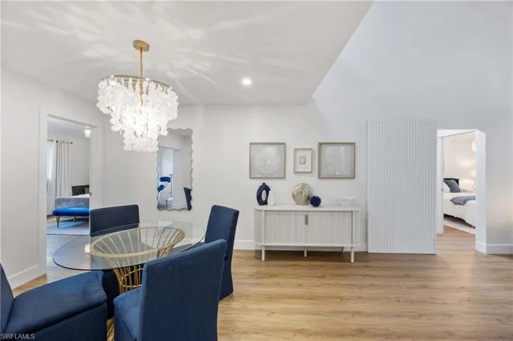 Dining area with a notable chandelier and light wood-type flooring