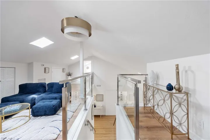 Bathroom featuring lofted ceiling and wood-type flooring