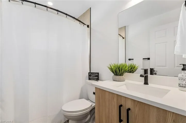 Bathroom featuring vanity and a shower with shower curtain