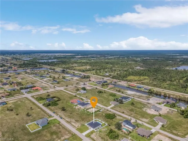 Aerial perspective of suburban area featuring a nearby body of water