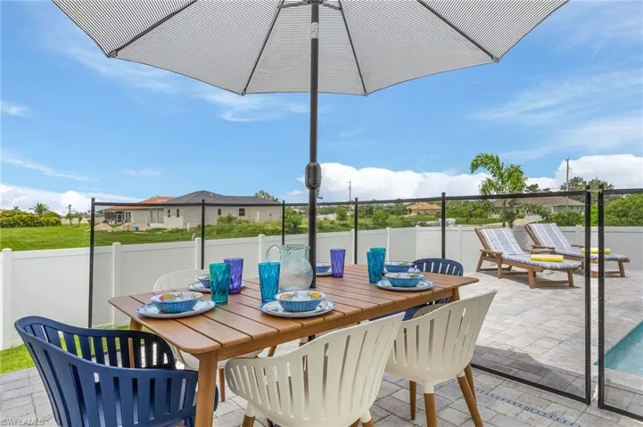 Fenced backyard with outdoor dining area