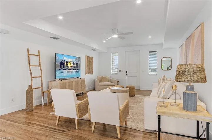 Living area with a ceiling fan, light wood-style floors, and recessed lighting