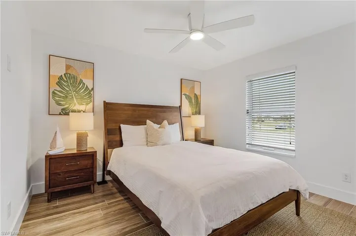 Bedroom with light wood finished floors and ceiling fan