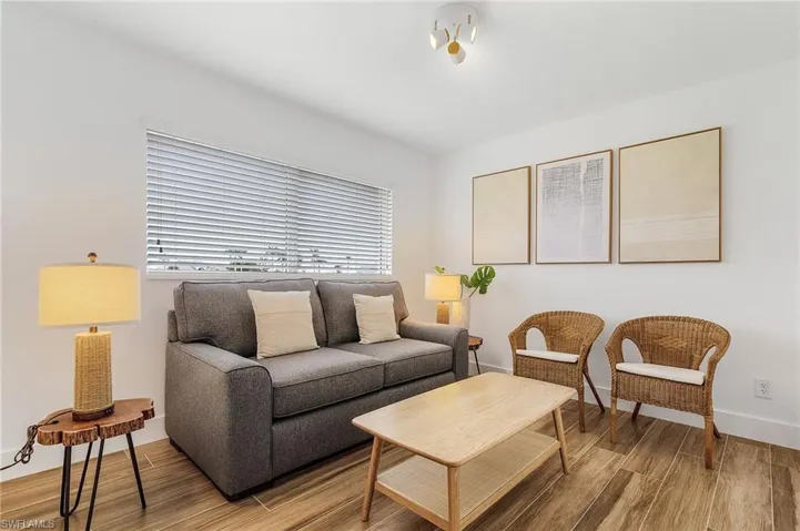 Living area featuring wood tiled floors and baseboards