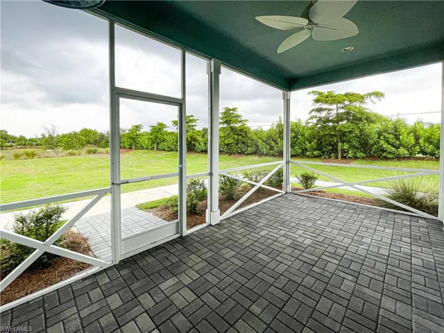 Unfurnished sunroom with ceiling fan