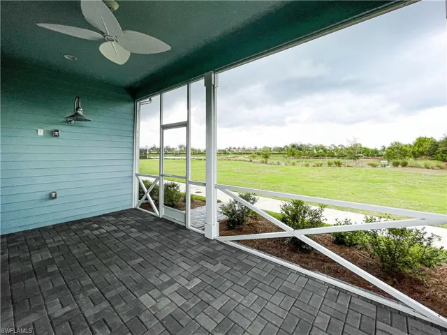 Unfurnished sunroom with ceiling fan